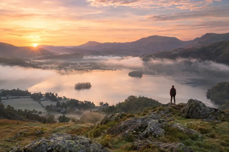 A wide landscape photograph of hills at dusk